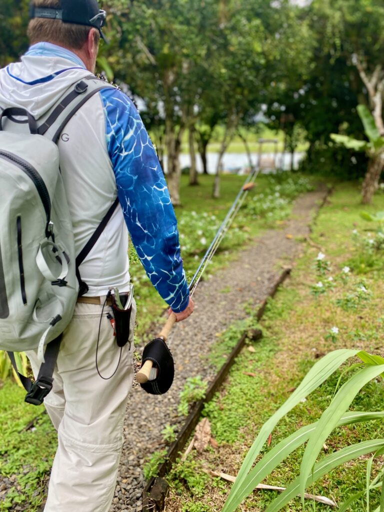 Angler carrying a Water First fly rod