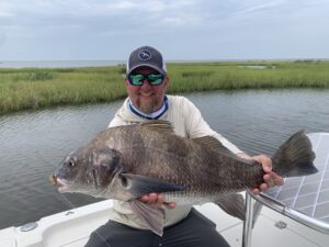 Angler holding a fish caught on a Water First fly rod